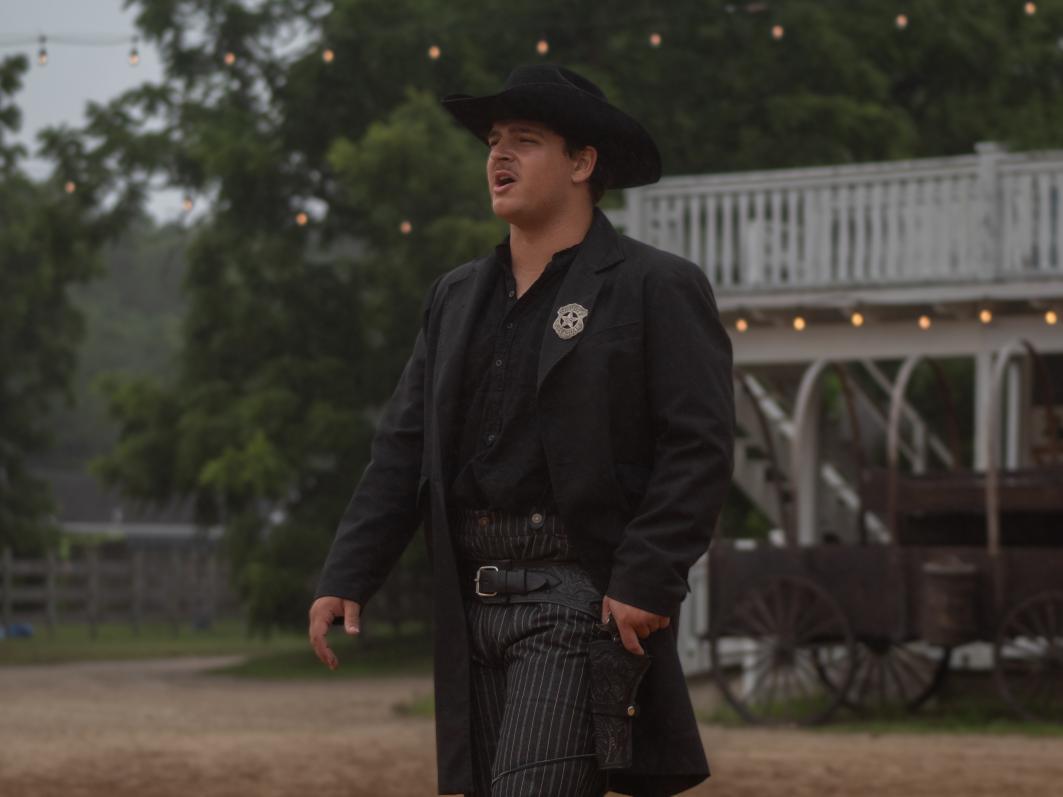 Nicolas performing in a Western costume